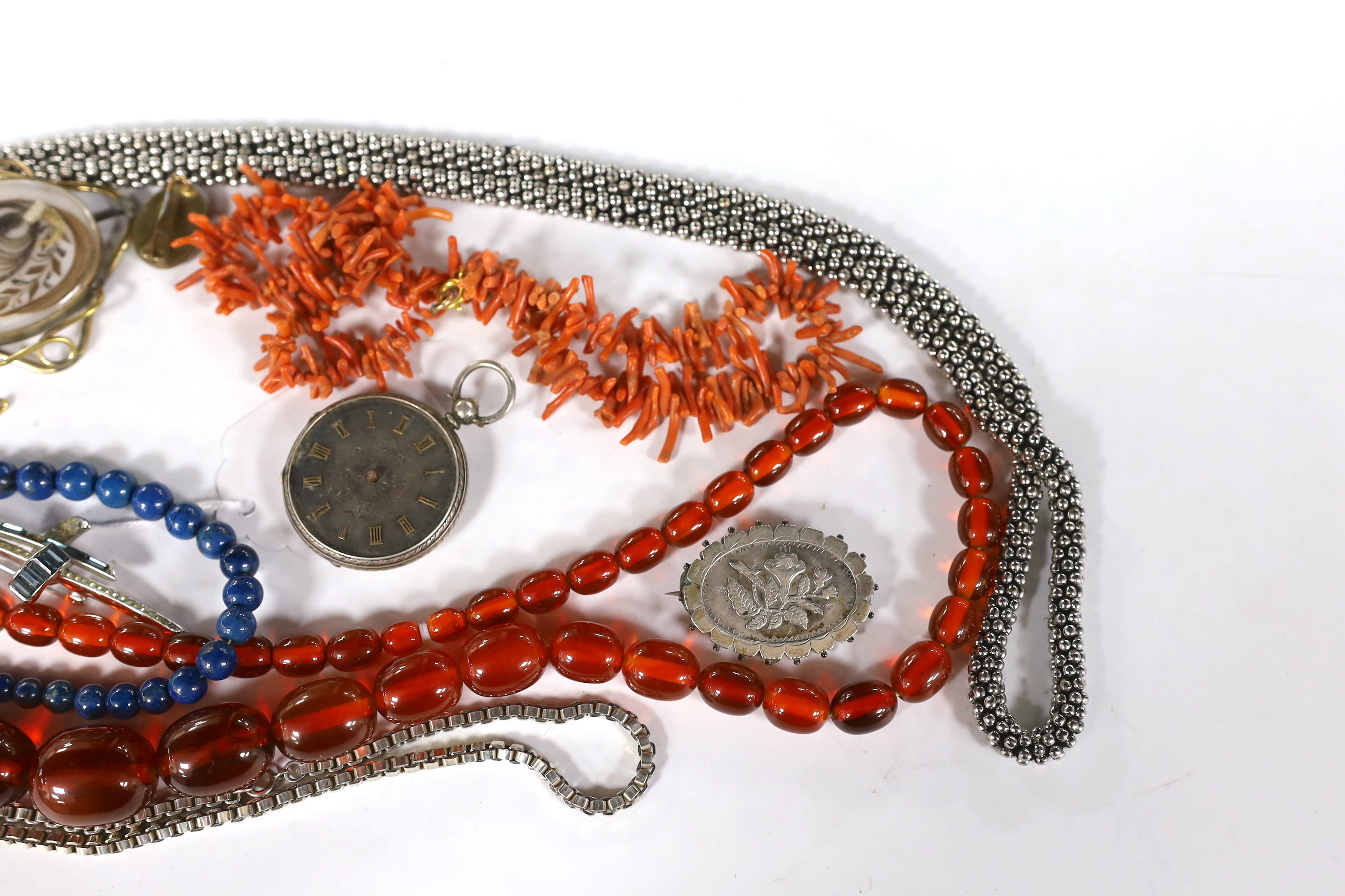 Assorted jewellery including a graduated simulated amber bead necklace, coral branch necklace, white metal oval brooch, Victorian mourning brooch etc.